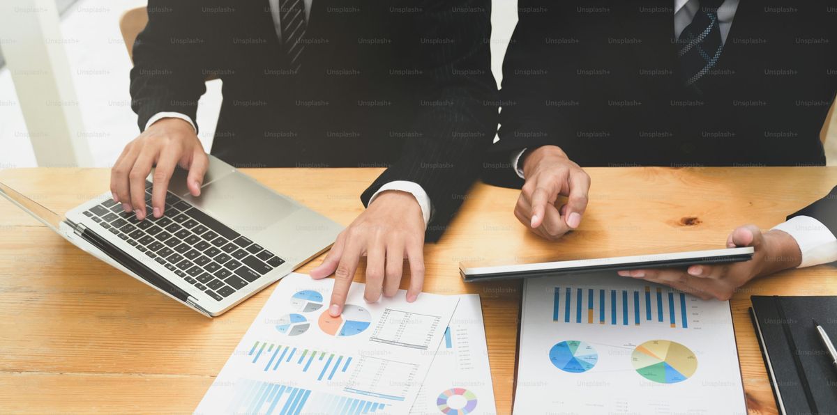 Business strategy consulting session with team reviewing documents